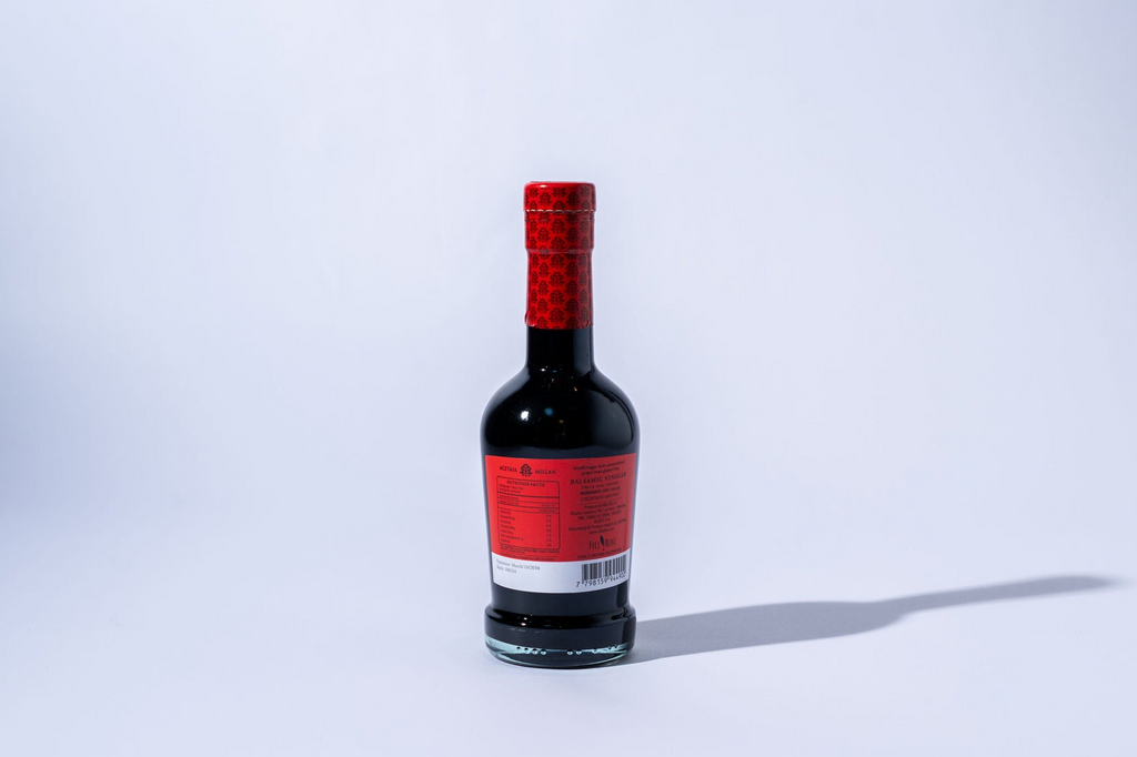 balsamic bottle with a red label on a white background