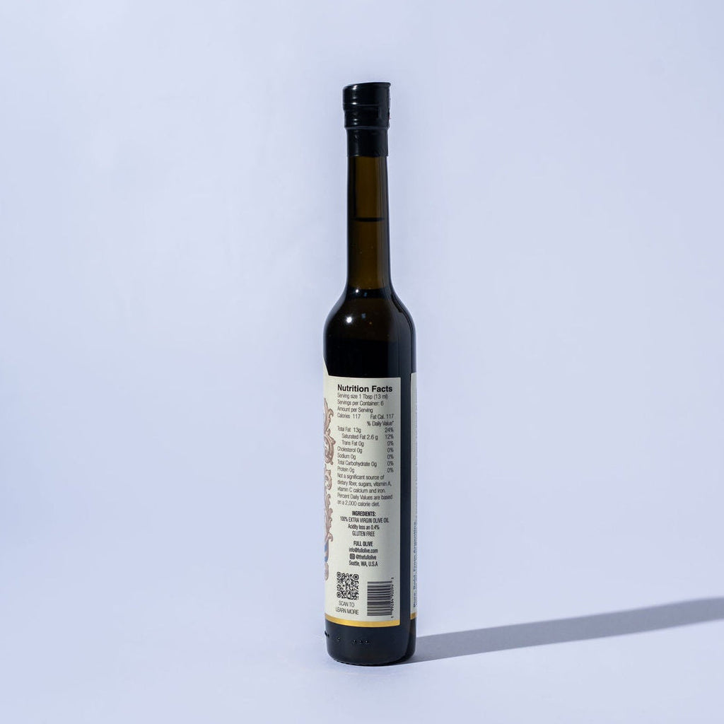 Bottle of olive oil with a label on a light blue background