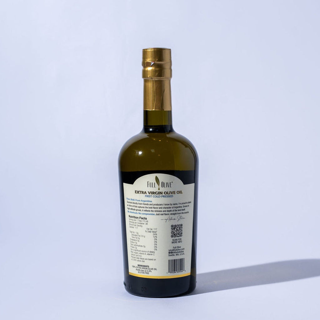 Bottle of olive oil with a label on a light gray background
