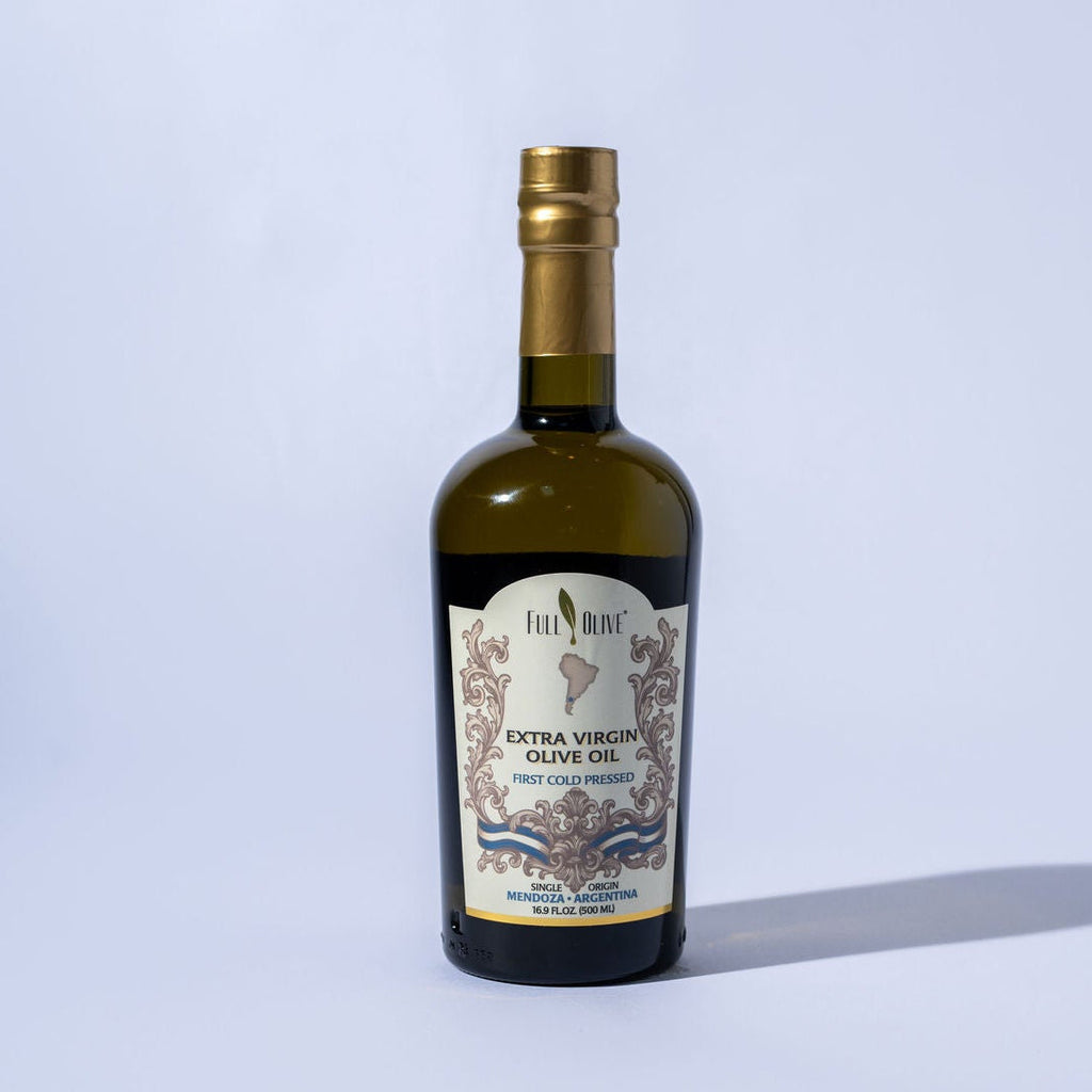 Bottle of olive oil with a label on a light gray background