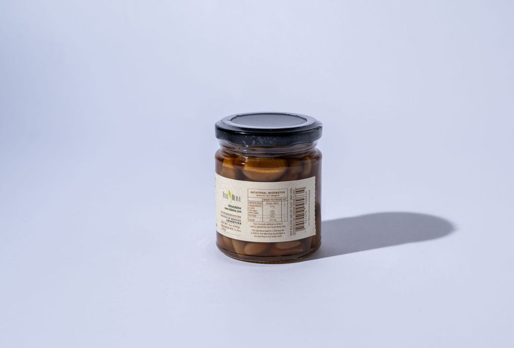 Jar of honey with a label on a light gray background