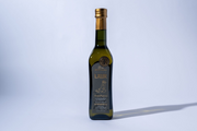 Bottle of olive oil with a label on a light gray background