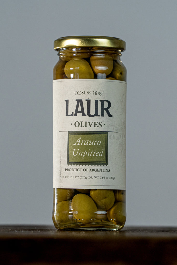 Close-up of Green Arauco Olives - Unpitted 100% Arauco. Handpicked and preserved in brine, these vibrant green olives offer a fresh, authentic flavor, reflecting Laur's commitment to quality and tradition