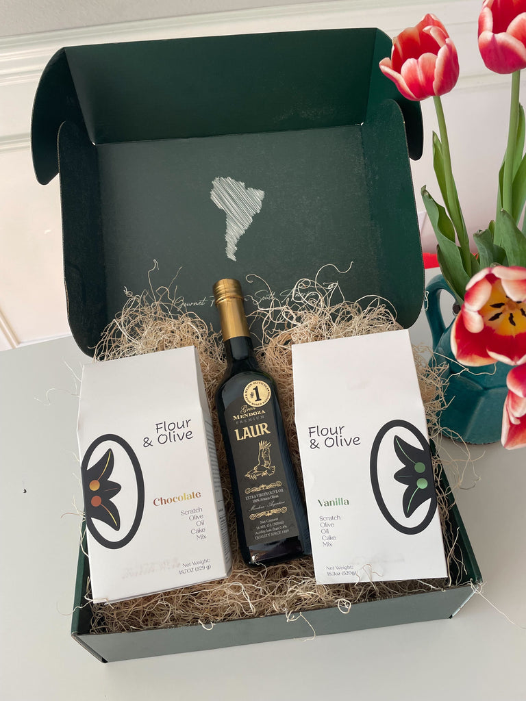 A baking box containing a bottle of Gran Mendoza olive oil and two packages of flour and olive cake mix, ready for creating delicious baked goods