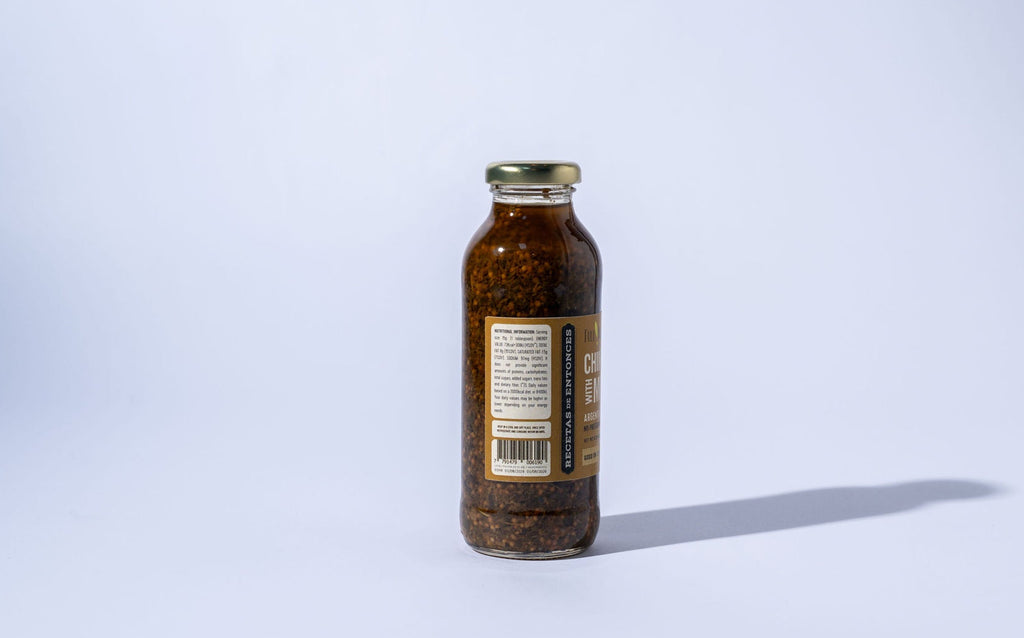 Bottle of chimichurri mustard with a label on a light gray background