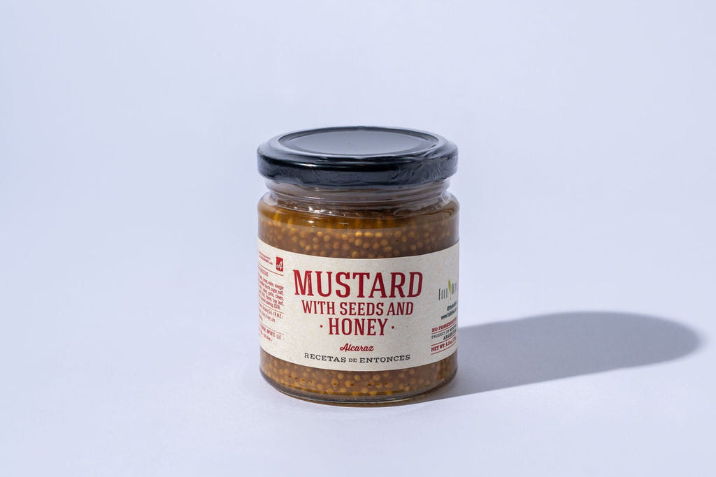 Jar of honey mustard with a label on a white background