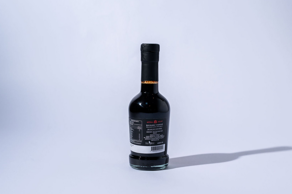 Black bottle picante balsamic with a label on a white background