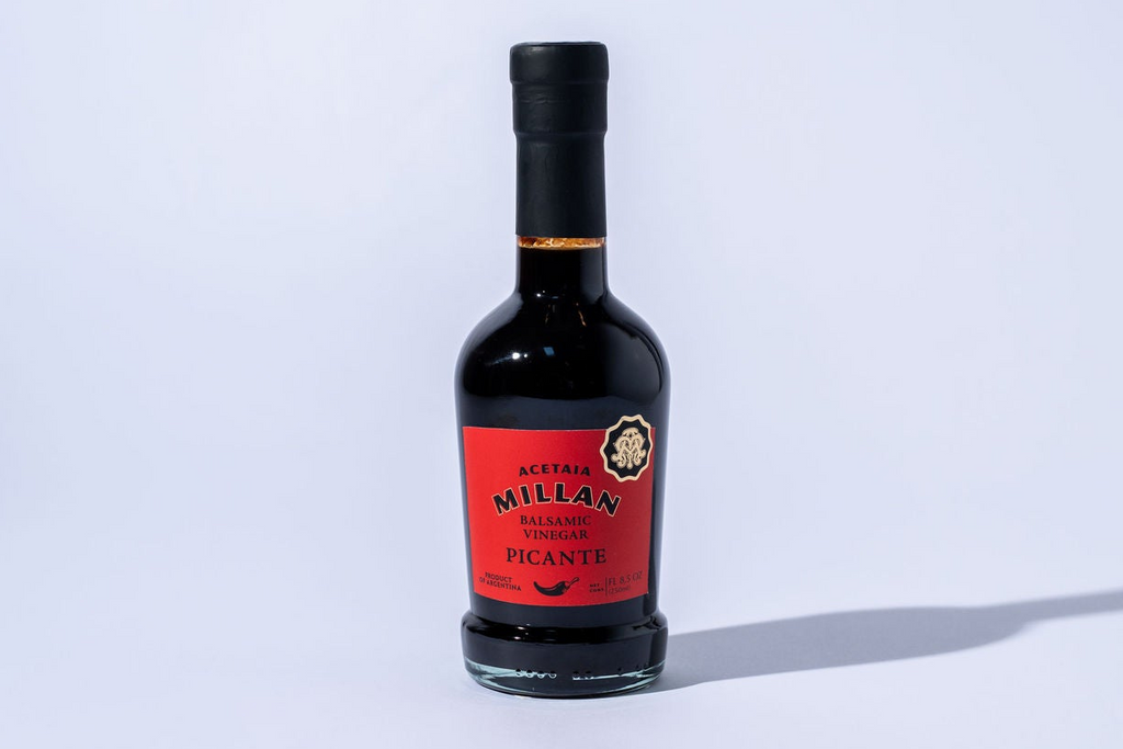 Bottle of picante Balsamic Vinegar on a light gray background