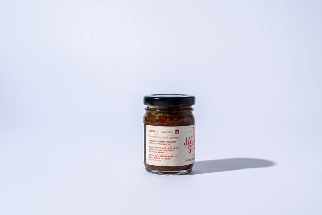 Jar of jalapeno jelly on a white background