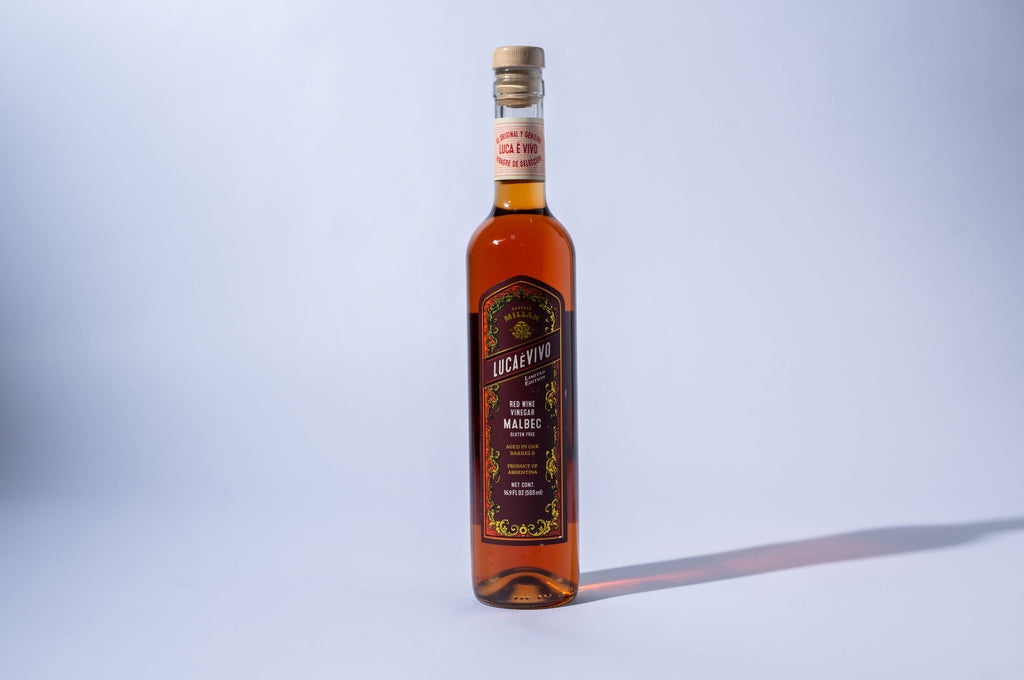 Bottle of red wine vinegar  on a light gray background