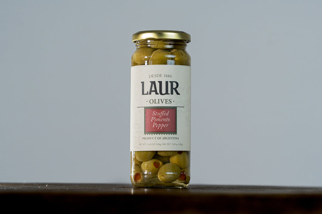 Close-up of Stuffed Pimento Olives, featuring vibrant green olives filled with savory pimento. A delicious and flavorful snack or addition to appetizers.