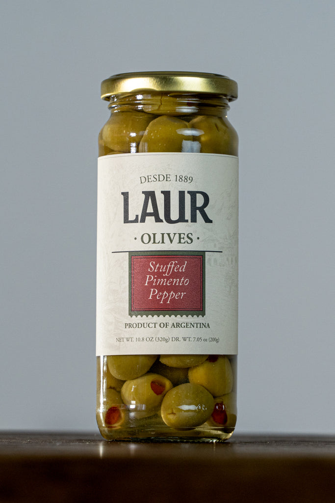 Close-up of Stuffed Pimento Olives, featuring vibrant green olives filled with savory pimento. A delicious and flavorful snack or addition to appetizers.