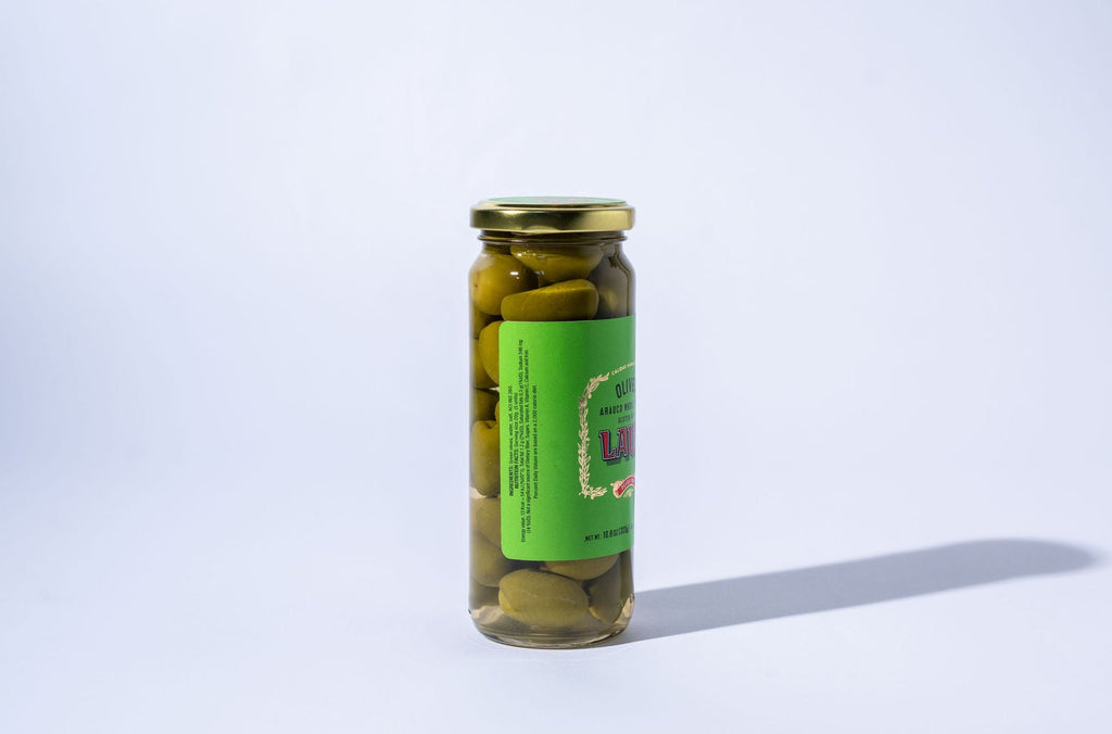 Jar of pickles with a green label on a white background