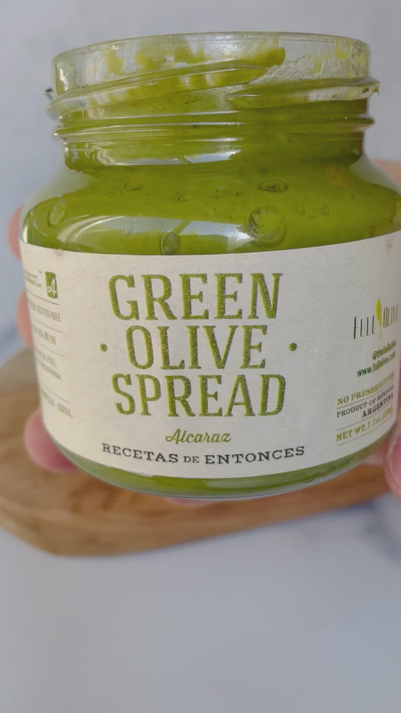 A video of Green Olive Spread, being spread on a cracker highlighting the rich green color and savory nature of the spread